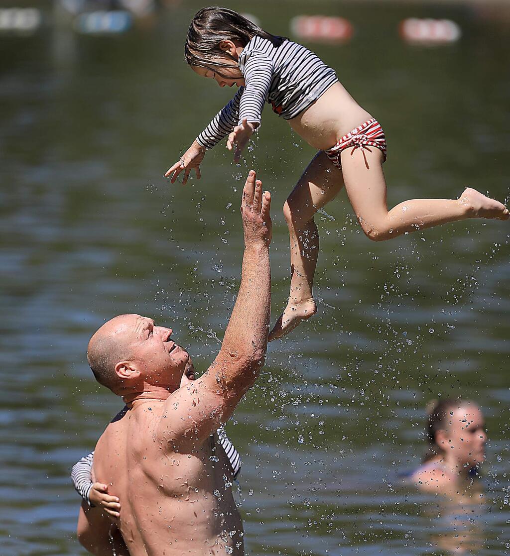 Ron Rosser plays with daughter Aubrey, 4, at the Spring Lake swimming lagoon, Wednesday, June 20, 2018 in Santa Rosa. In his left arm is his other daughter, Reese, 5. (KENT PORTER/ PD)