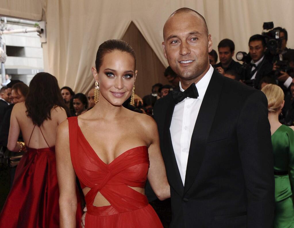 FILE - In this May 4, 2015, file photo, Derek Jeter, right, and Hannah Davis arrive at The Metropolitan Museum of Art's Costume Institute benefit gala celebrating 'China: Through the Looking Glass' in New York. Hannah Jeter announced on Monday, Feb. 13, 2017, that the couple is expecting their first child together. (Photo by Charles Sykes/Invision/AP, File)