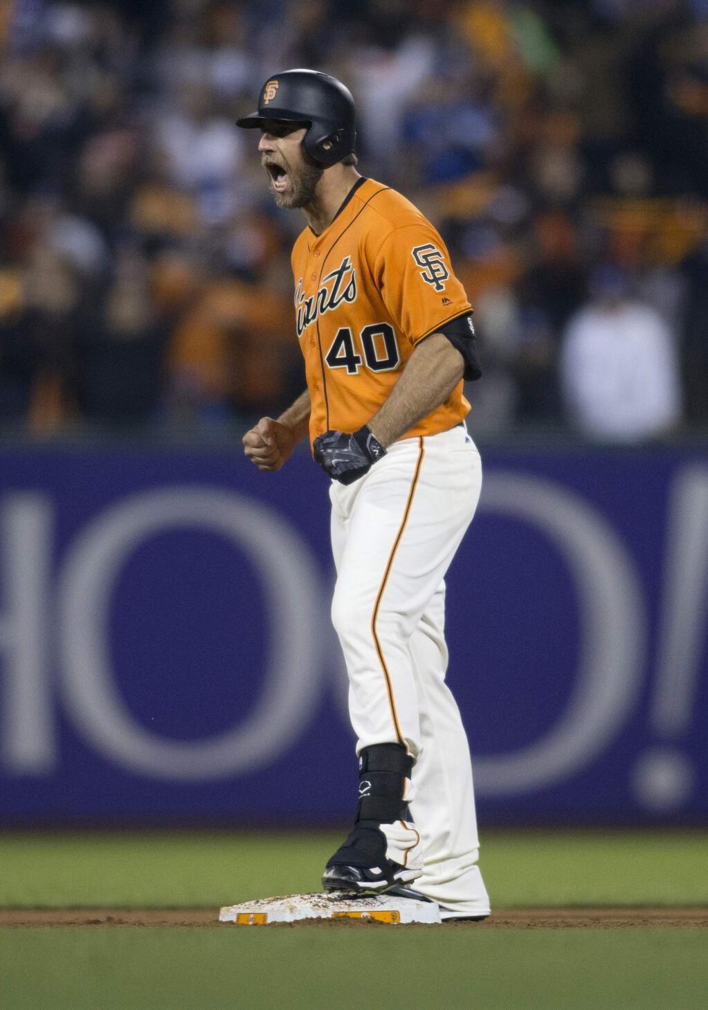 San Francisco Giants starting pitcher Madison Bumgarner reacts to his two-run double against the Los Angeles Dodgers during the sixth inning of a baseball game, Friday, Sept. 30, 2016, in San Francisco. (AP Photo/D. Ross Cameron)