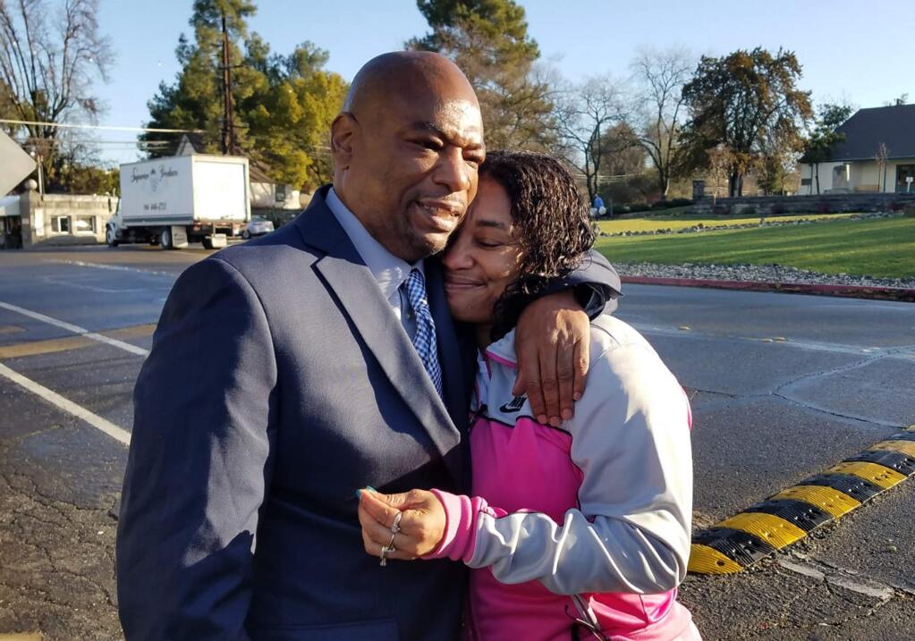 This photo released by the California Innocence Project shows Quintin Morris, 53, embracing his sister Billie Sullivan after he was released from Folsom Prison after spending 27 years behind bars for attempted murders he denied committing, outside the prison in Folsom, Calif., Thursday, Jan. 10, 2019. Then-Gov. Jerry Brown commuted Morris's 1994 potential life sentence last August, allowing him to be granted parole. He's expected to spend some time in a halfway house in the Los Angeles area. (Alissa Bjerkhoel/California Innocence Project via AP)