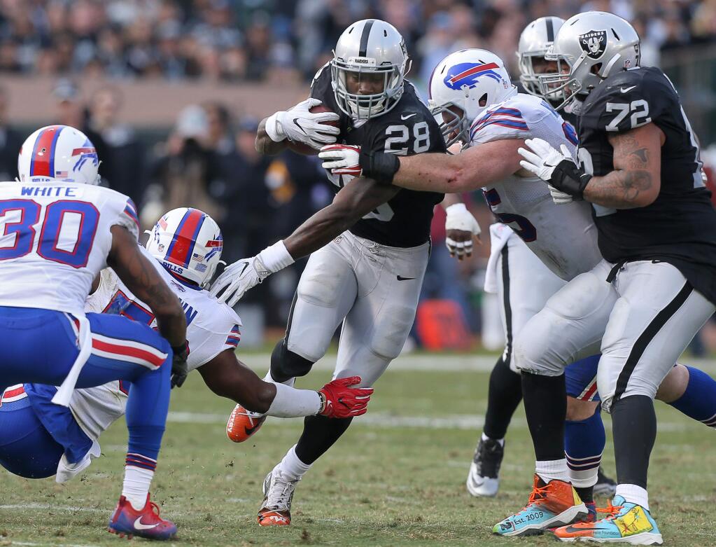 Oakland Raiders running back Latavius Murray runs the ball against the Buffalo Bills during their game in Oakland on Sunday, December 4, 2016. The Raiders defeated the Panthers 38-24.(Christopher Chung/ The Press Democrat)