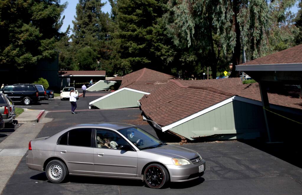 Parking structures crushed cars after they collapsed at Charter Oaks Apartments during a 6.0 earthquake in on Sunday, August 24, 2014 in Napa, California. (BETH SCHLANKER/ The Press Democrat)