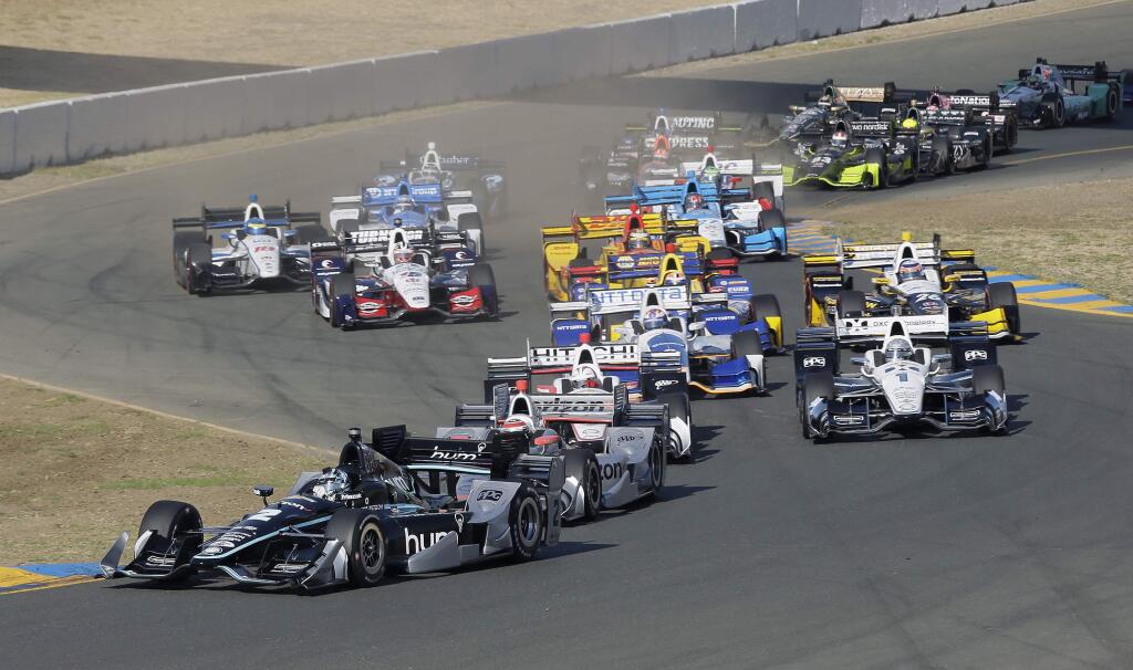 Josef Newgarden (2) leads cars through Turn 2 at the start of the IndyCar race Sunday, Sept. 17, 2017, in Sonoma. (AP Photo/Eric Risberg)