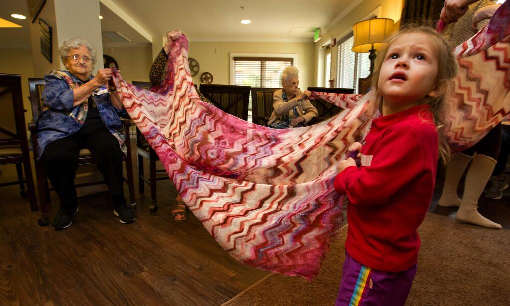john Burgess / The Press DemocratMillie Rogina, left, scarf dances with Kian Coates-Hood, 2, during a Music Together class at the Sunrise Villa in Santa Rosa on March 9. Rogina died April 20 at 92.