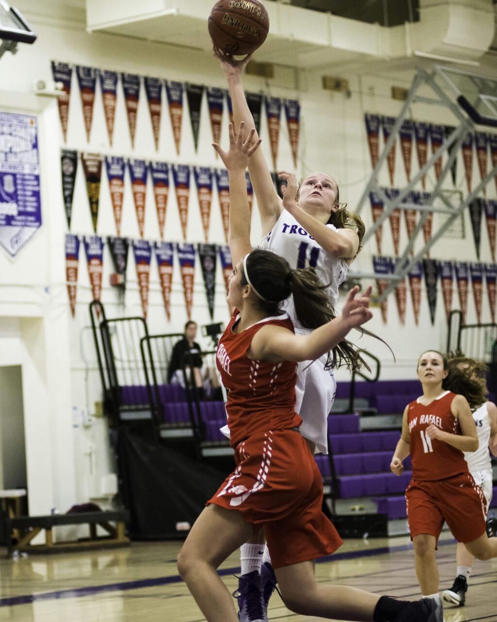RICH LANGDON/FOR THE ARGUS-COURIERPetaluma's Nicole Costa rises above a San Rafael defender to score two of her game-high 14 points in the T-Girls victory.