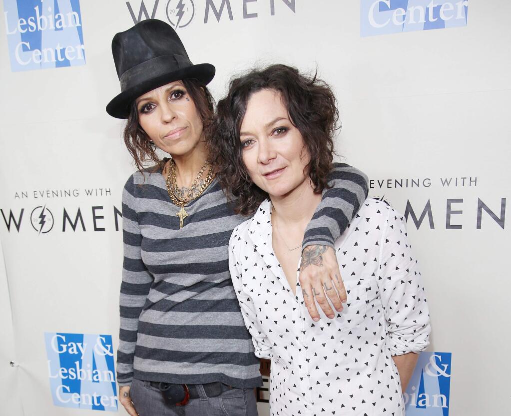 FILE - In this March 15, 2014 file photo, Linda Perry, left, and Sara Gilbert arrive at L.A. Gay and Lesbian Center 'An Evening with Women' Kick Off Concert Event in West Hollywood, Calif. Gilbert shared the news of her new baby on ìThe Talk.î Co-host Julie Chen announced on the Monday, March 2, 2015, episode that Gilbert welcomed a son, Rhodes Emilio Gilbert Perry, over the weekend, her first with wife, Perry. (Photo by Annie I. Bang /Invision/AP, File)