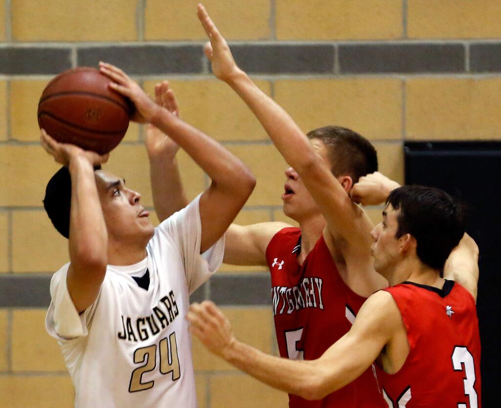 Windsor's Gabe Knight (24) looks to shoot past Montgomery's Joel Seitz (5), center, and Lane Young (3) during the first half of the NCS Division 2 boys basketball quarterfinal game between Montgomery and Windsor high schools in Windsor, California, on Friday, Feb. 26, 2016. (ALVIN JORNADA/ PD FILE)