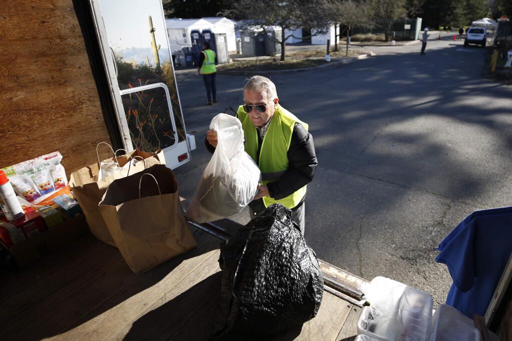 Oakmont resident Peter Hardy drops off items donated by members of the Star of the Valley Roman Catholic Church at the Los Guilicos homeless encampment in Santa Rosa, California on Monday, February 3, 2020. (BETH SCHLANKER/The Press Democrat)
