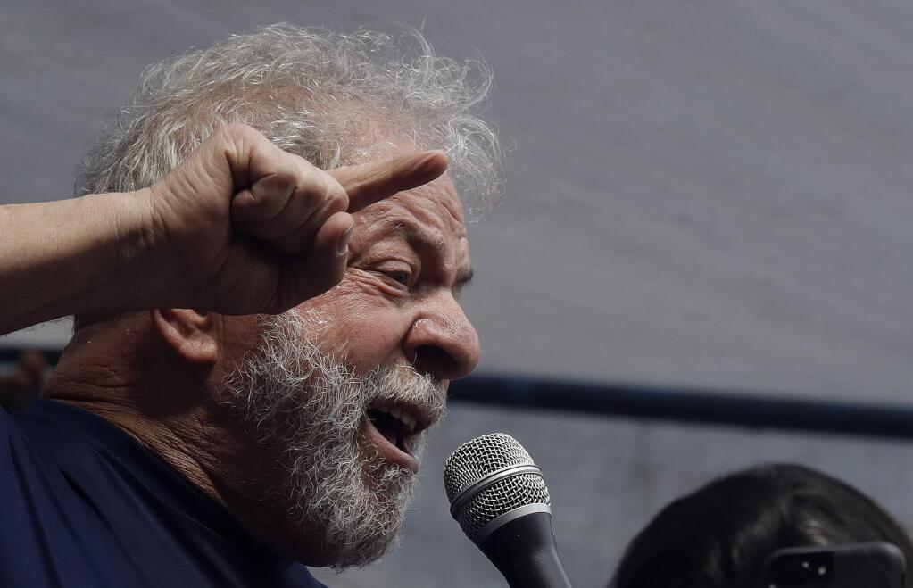Brazilian former President Luiz Inacio Lula da Silva delivers a speech outside the Metal Workers Union headquarters in Sao Bernardo do Campo, Brazil, Saturday, April 7, 2018. Da Silva told supporters he will comply with an arrest warrant and turn himself in to police, to begin serving a sentence of 12 years and one month for a corruption conviction. (AP Photo/Andre Penner)