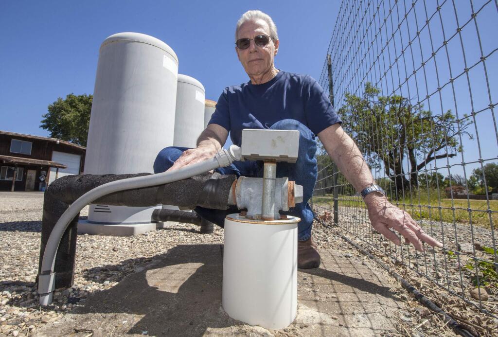 Ray Larbre, of Larbre Well Drilling & Pumps, at one the three wells on his Arnold Drive Property. This well reachers a depth of 1000 feet and is used to monitor groundwater levels on the west side of the valley. Larbre, who's been keeping records since the 1990s, measures these levels twice a year, in the spring and in the fall, and says that since he started keeping records, the groundwater level has declined about 60 feet. (Photo by Robbi Pengelly/Index-Tribune)