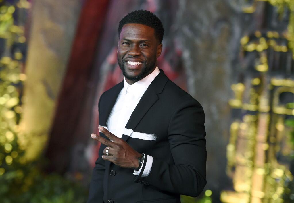 FILE - In this Dec. 11, 2017 file photo, Kevin Hart arrives at the Los Angeles premiere of 'Jumanji: Welcome to the Jungle' in Los Angeles. Hart will host the 2019 Academy Awards, fulfilling a lifelong dream for the actor-comedian. Hart announced Tuesday, Dec. 4, 2018, his selection in an Instagram statement and the Academy of Motion Picture Arts and Sciences followed up with a tweet that welcomed him 'to the family.' (Photo by Jordan Strauss/Invision/AP, File)