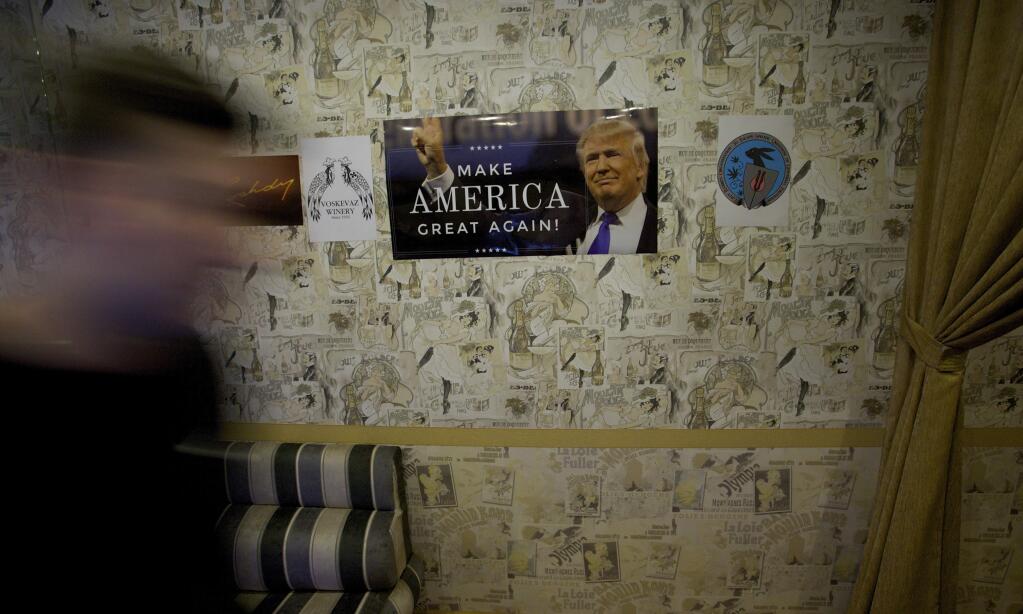 A visitor arrives for a party to mark the upcoming inauguration of Trump at a nightclub in Moscow, Russia, on Thursday, Jan. 19, 2017. Twenty-four hours before Donald Trump is to be sworn in as president of the United States, people gathered at a Moscow nightclub to celebrate his inauguration. (AP Photo/Ivan Sekretarev)