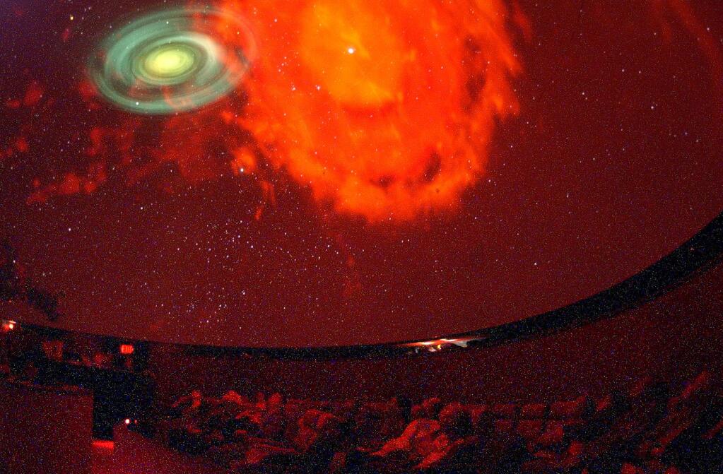 2/23/2006: D3: none4/11/2002: D1: An eerie red pall is cast upon the audience as it looks up at a projection of a nebula and galaxy on the dome of the planetarium.PC: The SRJC planetarium illuminates nebula's and star systems on the dome of planetarium.