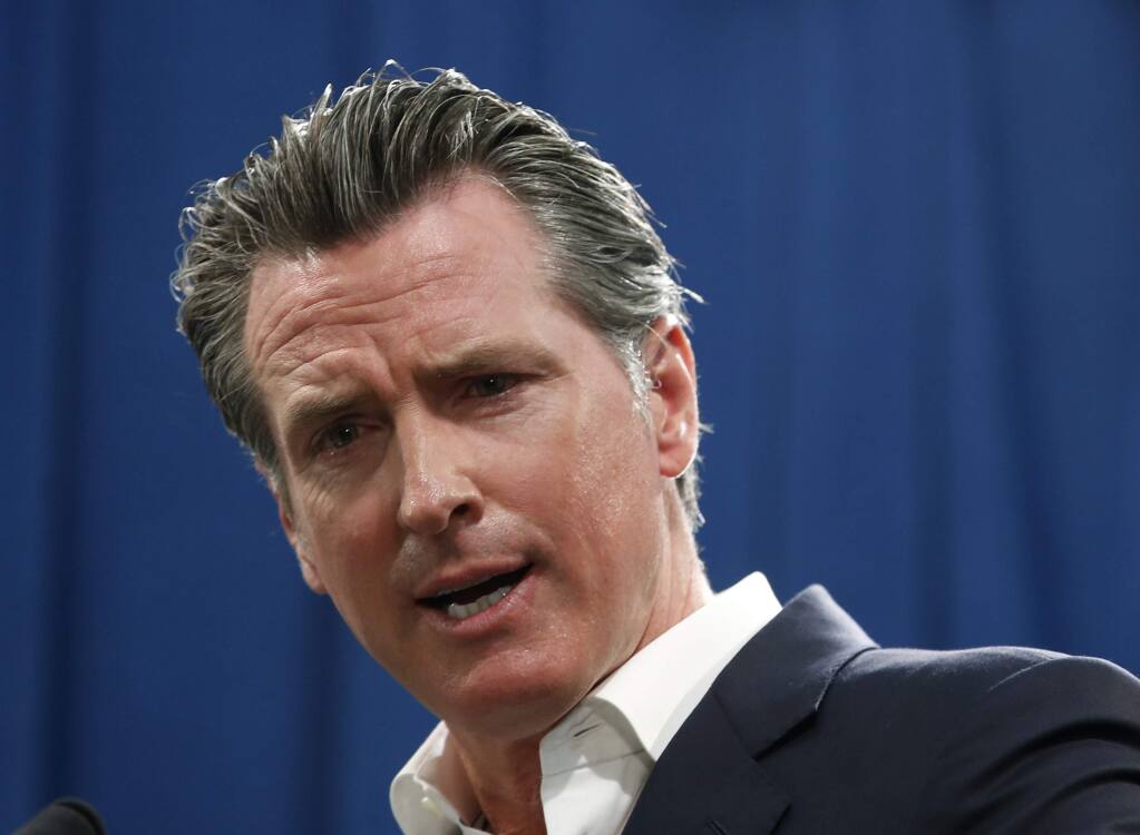 FILE - In this Sept. 16, 2019, file photo, Gov. Gavin Newsom answers a question during a news conference in Sacramento, Calif. Newsom announced Monday, Sept. 30, he signed a law that would let athletes at California universities make money from their images, names or likenesses. The law also bans schools from kicking athletes off the team if they get paid. (AP Photo/Rich Pedroncelli, File)
