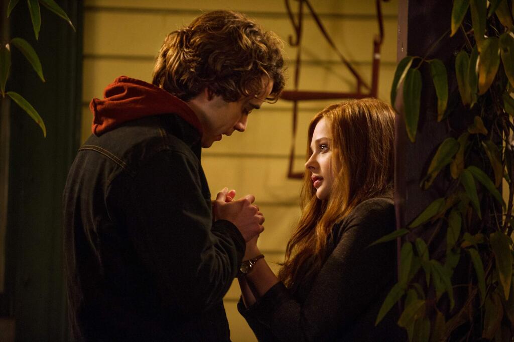 This image released by Warner Bros. Pictures shows Jamie Blackley, left, and Chloe Grace Moretz in a scene from 'If I Stay.' (AP Photo/Warner Bros. Pictures, Doane Gregory)