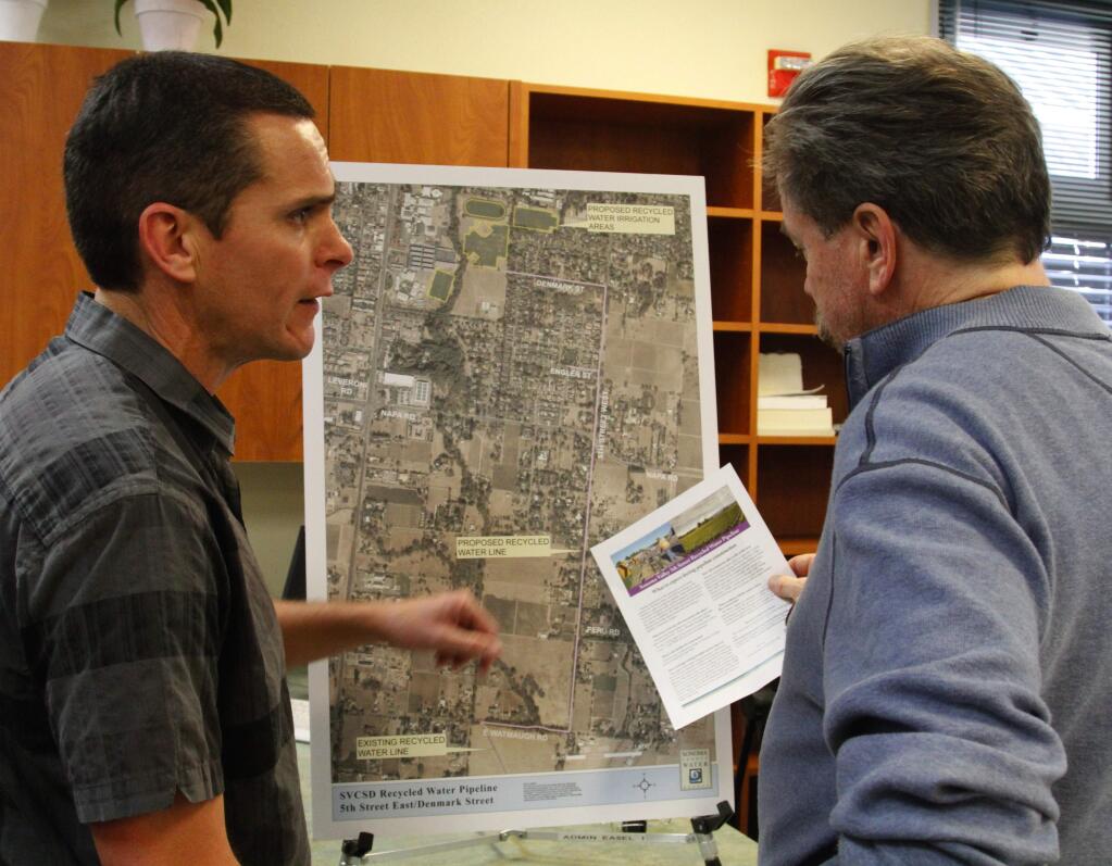 Bill Hoban/Index-TribuneMike West, left, a design engineer with the Sonoma County Water Agency, talks with Doug Mighell about the proposed recycled water pipeline that would run on Fifth Street East and Denmark Street to supply water to the school district.