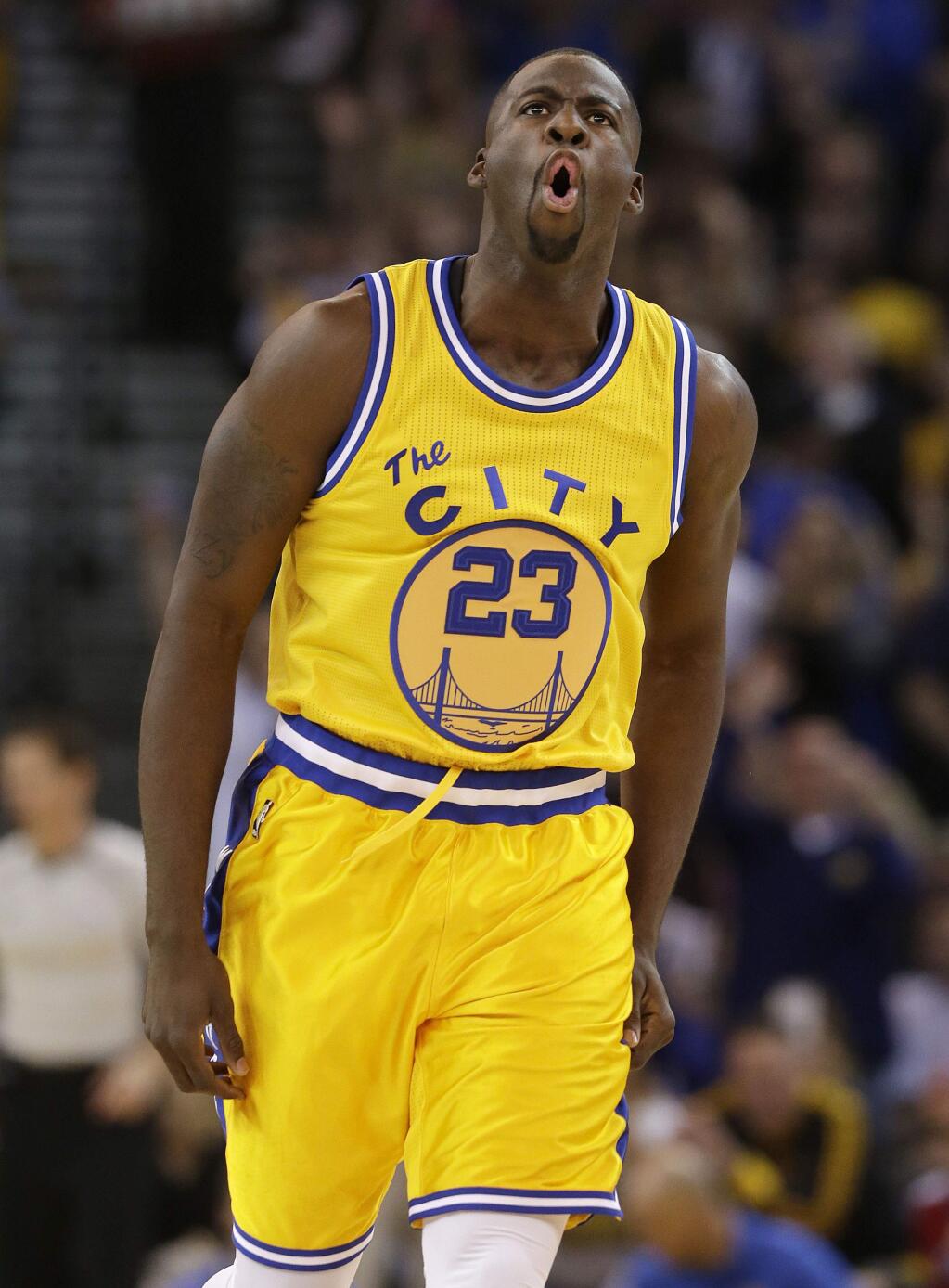 Golden State Warriors forward Draymond Green reacts after making a 3-point basket during the first half of an NBA basketball game against the Los Angeles Lakers in Oakland, Calif., Tuesday, Nov. 24, 2015. (AP Photo/Jeff Chiu)