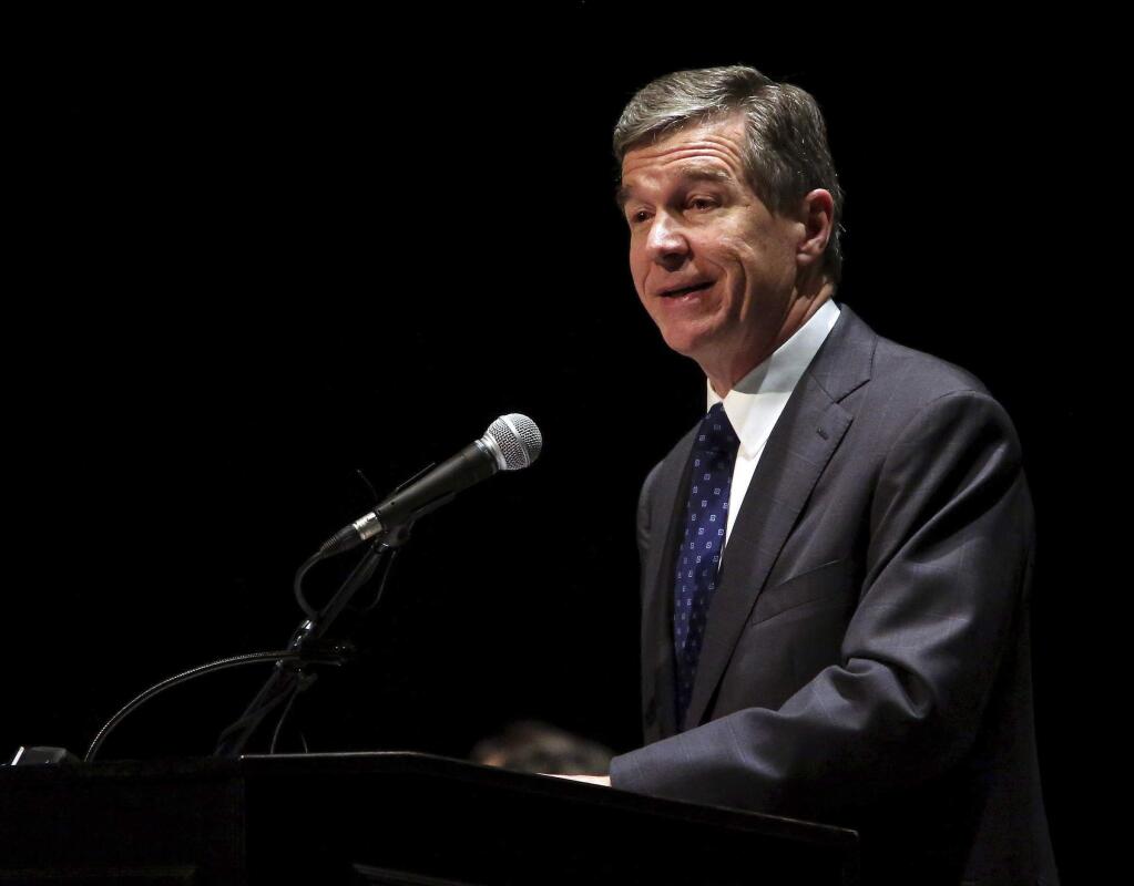 This photo taken Dec. 19, 2017, shows Gov. Roy Cooper announcing that Triangle Tire Company will be building a manufacturing facility at the Kingsboro megasite in Edgecombe County in Tarboro, N.C. Federal judges ruled Tuesday, Jan. 9, 2018, that North Carolina's congressional district map drawn by legislative Republicans is illegally gerrymandered due to excessive partisanship that gave GOP a rock-solid advantage for most seats and must quickly be redone. The ruling marks the second time this decade that the GOP's congressional boundaries in North Carolina have been thrown out by a three-judge panel. In 2016, another panel tossed out two majority black congressional districts initially drawn in 2011, saying there was no justification for using race as the predominant factor in forming them. The redrawn map was the basis for a new round of lawsuits.(Alan Campbell/The Rocky Mount Telegram via AP)