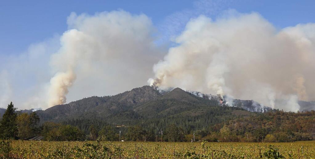 Fires send smoke billowing into the sky above Hood Mountain Regional Park and Sugarloaf Ridge State Park, east of Santa Rosa on Sunday, October 15, 2017. (Christopher Chung/ The Press Democrat)
