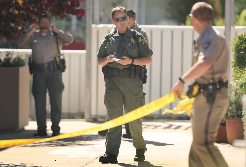 Sonoma County deputies and a CHP officer secure the scene of an officer-involved shooting at Fife Creek Commons in Guerneville on Wednesday April 29, 2015. (KENT PORTER/ PD)