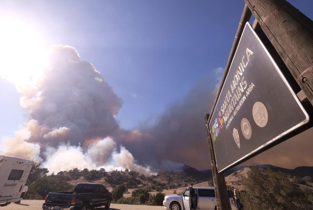 Smoke from the Woolsey fire rises over the Santa Monica Mountains National Recreation Area on Nov. 9. Almost 90 percent of the land in the park burned in the fire. (RINGO H.W. CHIU / Associated Press)