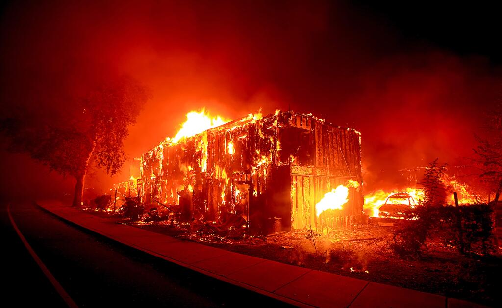 BEFORE: An apartment complex burns in Middletown, a victim of the Valley fire, Sunday morning Sept. 13, 2015. (Kent Porter / Press Democrat)