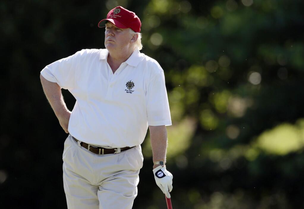 FILE - In this June 27, 2012, file photo, Donald Trump stands on the 14th fairway during a pro-am round of the AT&T National golf tournament at Congressional Country Club in Bethesda, Md. Donald Trump wants to make one thing perfectly clear ó he doesn't cheat in golf. Trump also says he has never played golf with former boxer Oscar De La Hoya, who earlier this week questioned Trump's integrity on the golf course. Trump told The Associated Press on Thursday, May 5, 2016, he respects the game too much to cheat and is good enough to have won a number of club championships. (AP Photo/Patrick Semansky, File)