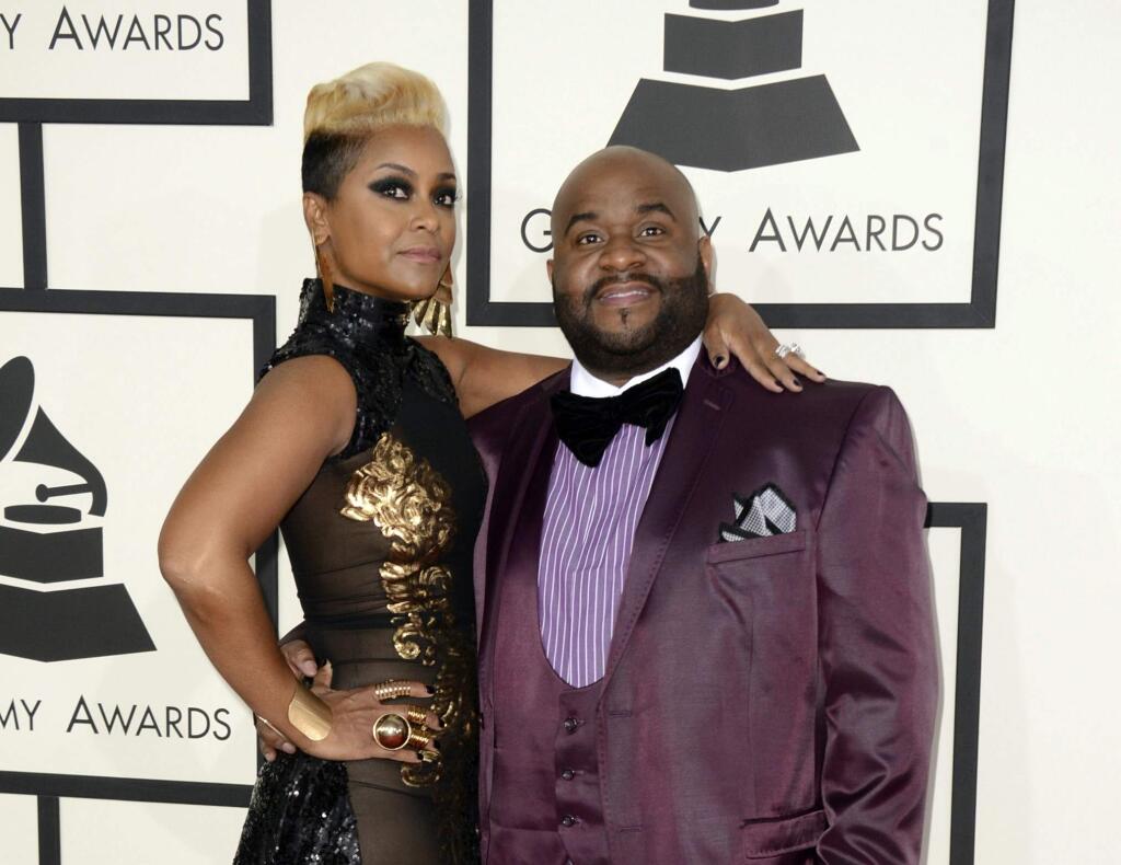 FILE - This Jan. 26, 2014 file photo shows songwriter LaShawn Daniels, right, and his wife, April Daniels, at the 56th annual Grammy Awards in Los Angeles. LaShawn Daniels, a Grammy Award-winning songwriter who penned songs for Beyoncé, Whitney Houston and Lady Gaga died, Tuesday, Sept. 3, 2019, in a fatal car accident in South Carolina. He was 41. He earned a Grammy in 2001 for his songwriting work on Destiny Child's “Say My Name.” (Jordan Strauss/Invision/AP, File)