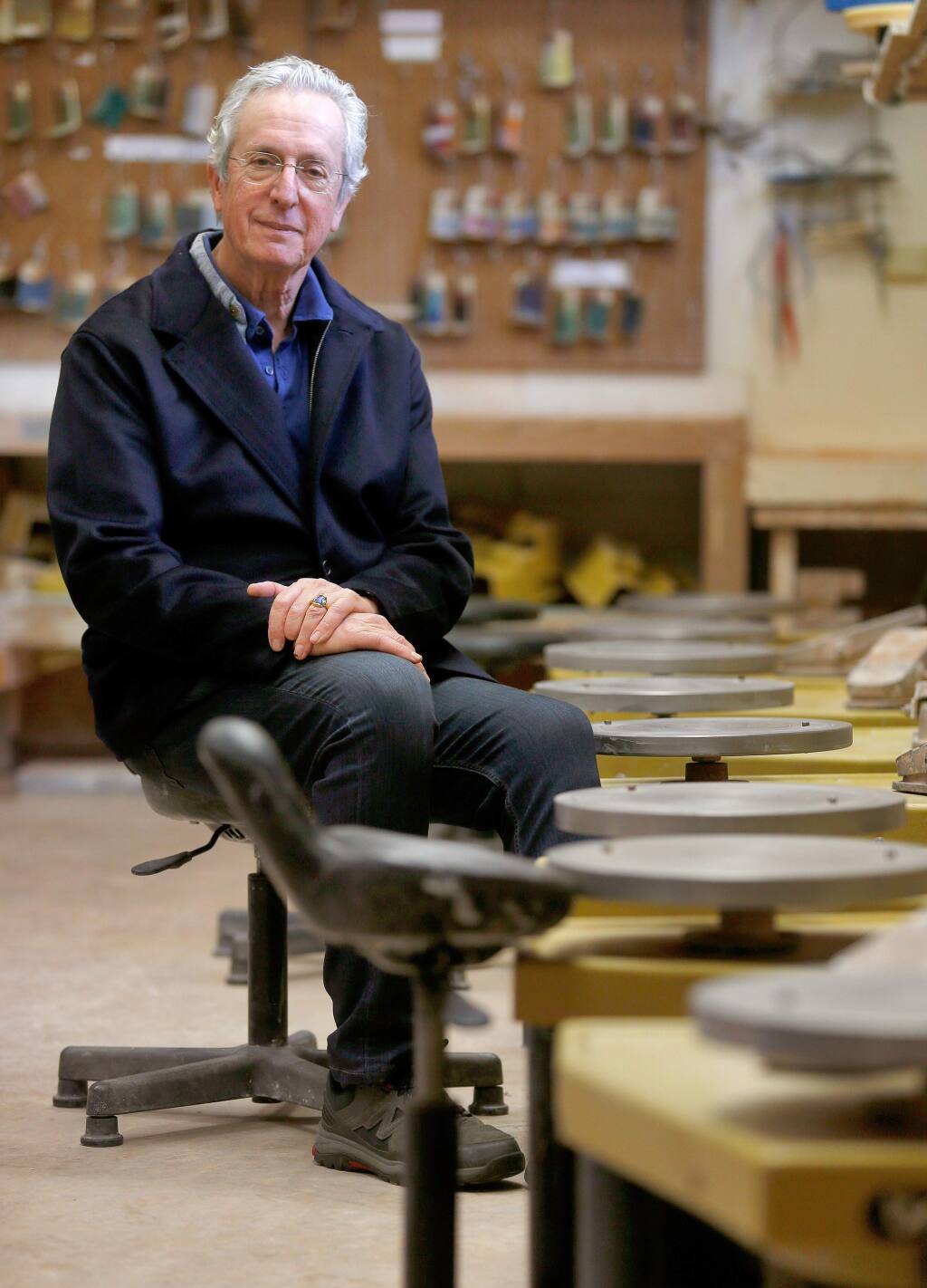 Robert Brent, board member of Sebastopol Center for the Arts and inventor of the Brent Pottery Wheel, poses for a portrait beside a row of his invention at Sebastopol Center for the Arts, in Sebastopol, California on Friday, January 5, 2018. (Alvin Jornada / The Press Democrat)