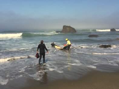 Lifguard Nate Buck retrieves the surfboard of a distressed surfer near Salmon Creek Beach on Wednesday, July 28, 2015. (COURTESY OF SUPERVISING STATE PARK RANGER JEREMY STINSON)