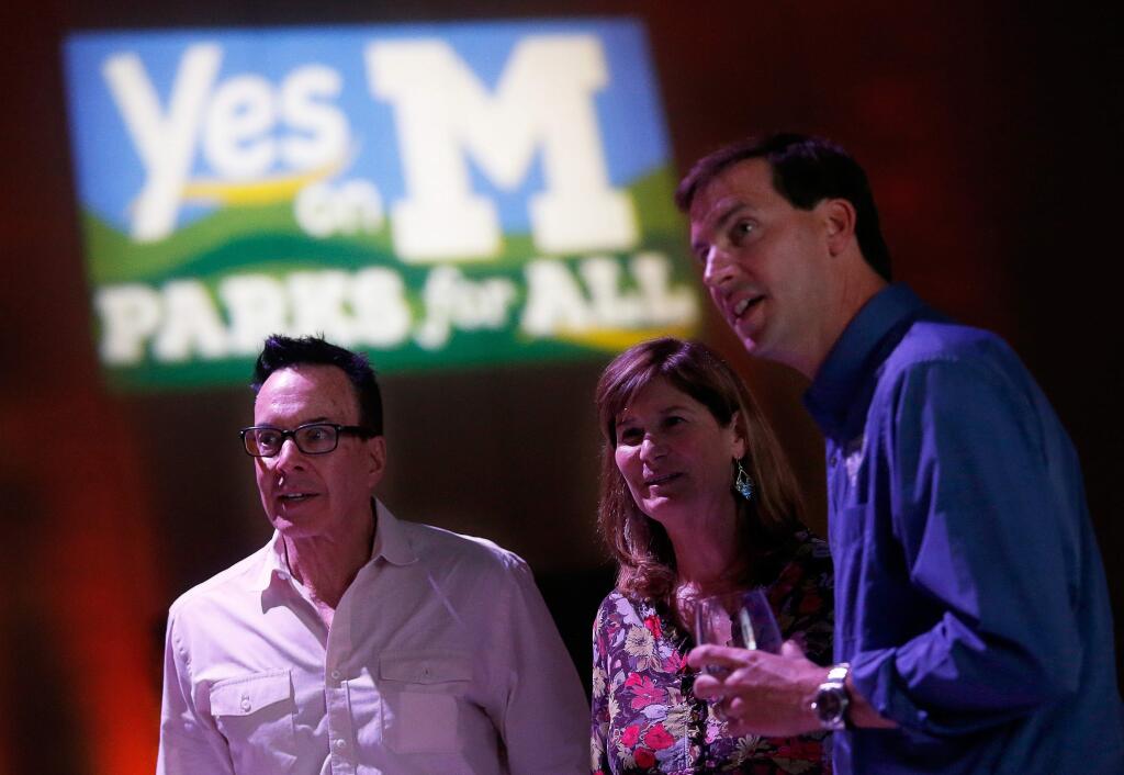 Greg Sarris, left, tribal chairman of the Federated Indians of Graton Rancheria, watches early election night results with Measure M campaign co-chair Caryl Hart and Sonoma County Regional Parks director Bert Whitaker during an election night watch party for supporters of Measure M at Graton Resort and Casino in Rohnert Park, California, on Tuesday, November 6, 2018. (Alvin Jornada / The Press Democrat)