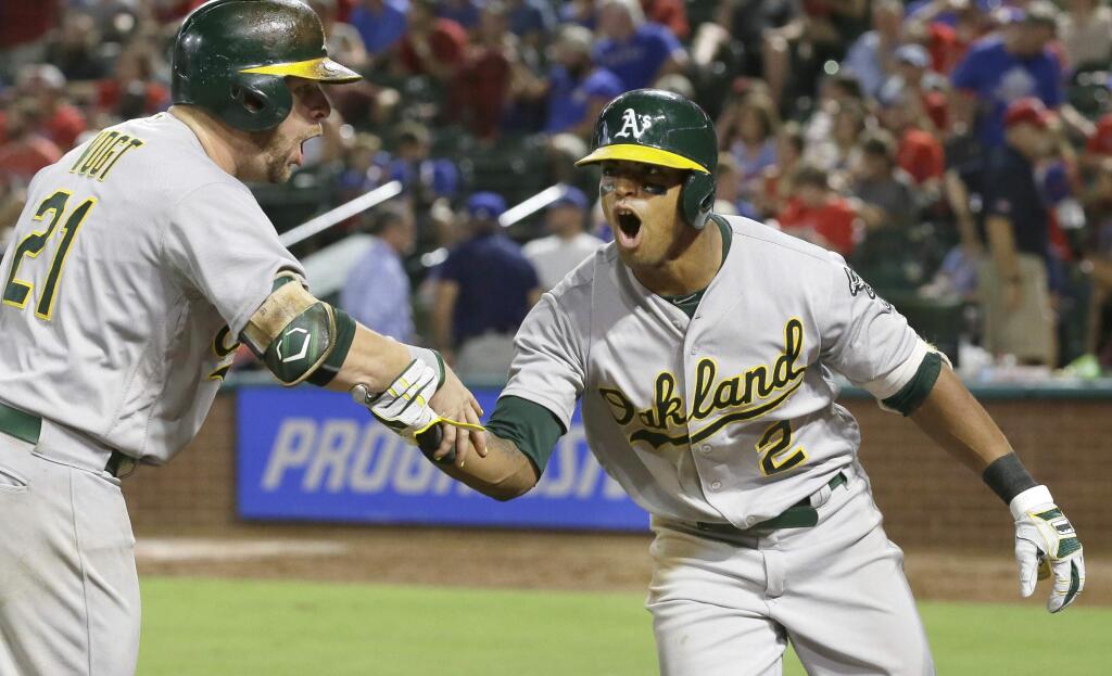 The Oakland Athletics' Khris Davis (2) celebrates his two-run home run with Stephen Vogt during the eighth inning against the Texas Rangers in Arlington, Texas, Wednesday, July 27, 2016. (AP Photo/LM Otero)