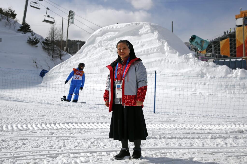 In this Feb. 12, 2018 photo, Sungsook Kim, a Catholic nun who goes by her religious name, Sister Droste, poses for a photograph at Phoenix Snow Park during the 2018 Winter Olympics in Pyeongchang, South Korea. Droste runs several centers spread across the sprawling Olympics venues to help sexual assault victims during the Winter Games. 'I am praying to God that nothing happens,' she says. 'But we are here.' (AP Photo/Patrick Semansky)