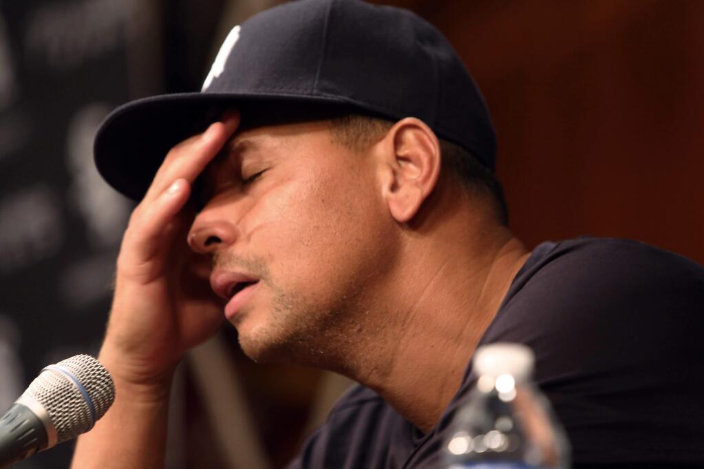FILE - In this Aug. 5, 2013 file photo, New York Yankees' Alex Rodriguez, with his hand to his head, talks during a news conference before the Yankees played the Chicago White Sox in a baseball game at US Cellular Field in Chicago. The owner of a now-defunct Florida clinic was charged Tuesday, Aug. 5, 2014, with conspiracy to distribute steroids, more than a year after he was accused of providing performance-enhancing drugs to Yankees star Alex Rodriguez and other players. Federal court records show Anthony Bosch is charged with one count of conspiracy to distribute testosterone. (AP Photo/Charles Cherney, File)