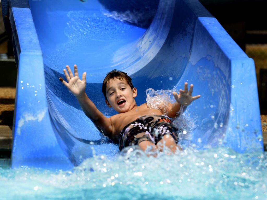 Gabriel Blakey, 8, rides a water slide at the Walter V. Graham Aquatic Center, Tuesday, June 30, 2015, in Vacaville, Calif. (Joel Rosenbaum/The Vacaville Reporter via AP) MANDATORY CREDIT