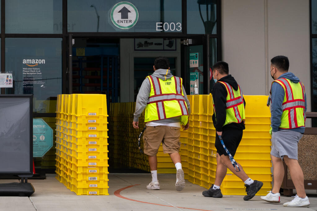 Workers enter an Amazon warehouse in Fresno on Feb. 4. Fresno, where the minimum rose to $14 an hour on Jan. 1, the fifth annual increase under a 2016 law, may be a laboratory for a debate that is heating up on the national level. (Sarahbeth Maney/The New York Times)