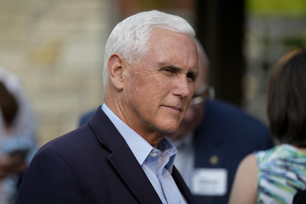 FILE - Former Vice President Mike Pence talks with local residents during a meet and greet on May 23, 2023, in Des Moines, Iowa. Pence will officially launch his widely expected campaign for the Republican nomination for president in Iowa on June 7. (AP Photo/Charlie Neibergall)