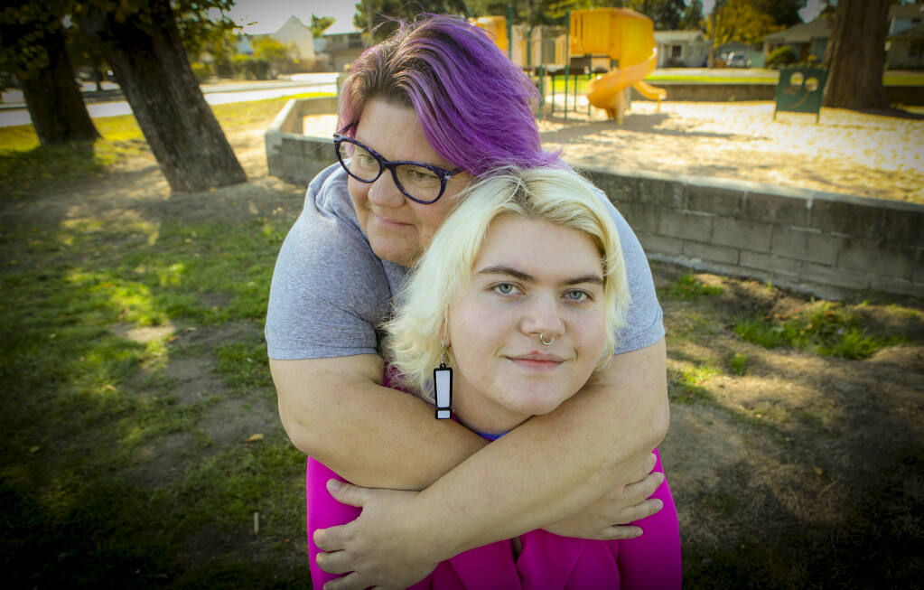 Lori Walter bear hugs her son Miles on Wednesday, Oct. 26, 2022, as they walk around the Petaluma neighborhood she grew up in and where she raised her sons. (CRISSY PASCUAL/ARGUS-COURIER STAFF)