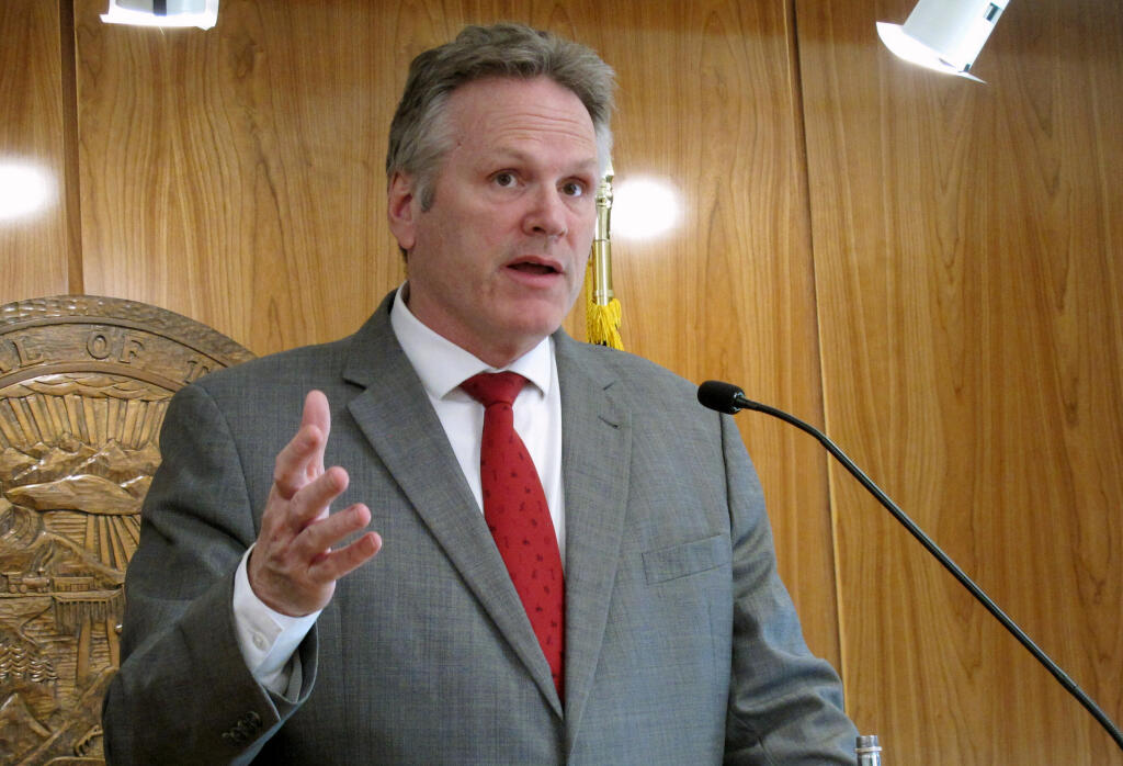 FILE - Alaska Gov. Mike Dunleavy speaks to reporters during a news conference at the state Capitol on April 28, 2022, in Juneau, Alaska. Nearly every single Alaskan got a financial windfall amounting to more than $3,000 on Tuesday, Sept. 20, 2022, the day the state began distributing payments from Alaska's investment fund that has been seeded with money from the state's oil riches. (AP Photo/Becky Bohrer, File)