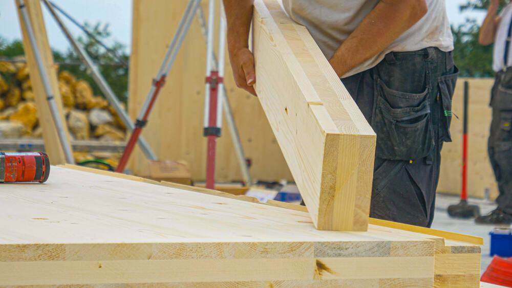 Here, a cross-laminated timber (CLT) beam, is used in a multi-story housing project. (Flystock / Shutterstock)