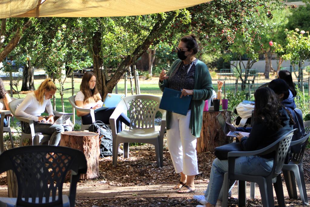 Marianne Rogoff, standing, teaches in one of the half-dozen outdoor classrooms Dominican University of California in San Rafael created as a way to be ultra-COVID safe. (David Albee Photo)