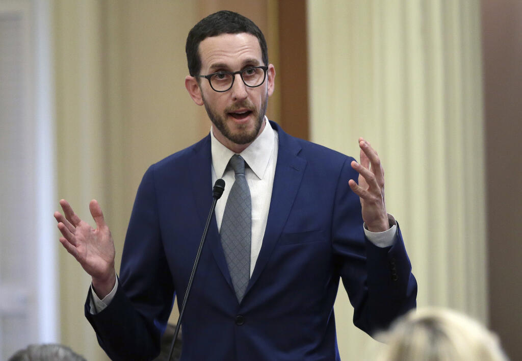 FILE - In this June 28, 2018, file photo, state Sen. Scott Weiner, D-San Francisco, talks during a Senate session in Sacramento, Calif. The Assembly Public Safety Committee approved Weiner's measure decriminalizing psychedelic substances, Tuesday June 29, 2021, after he amended his bill to remove a substance from the measure that opponents said can be used as a date-rape drug. (AP Photo/Rich Pedroncelli, File)