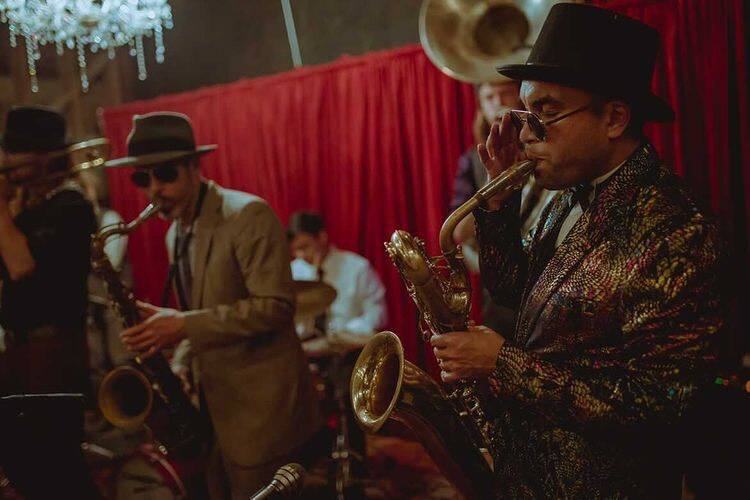 From left, tenor saxophonist Michael Fallon, drummer Mario Aparicio, sousaphone player Andros Howes and baritone saxophonist Brendan Buss of the Black Sheep Brass Band perform at a Roaring '20s-themed birthday party and in 2021 at the Green Valley Farm and Barn. (Bradley Jacob Cox)