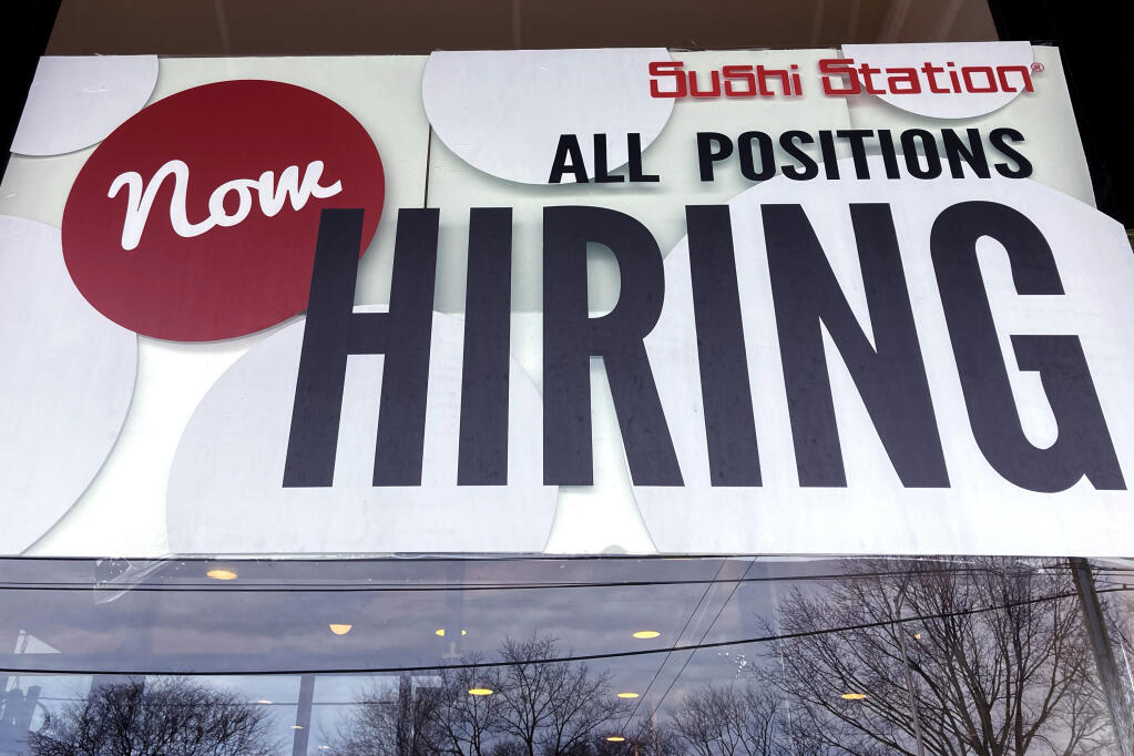 A hiring sign is displayed at a restaurant in Rolling Meadows, Ill., Tuesday, Dec. 27, 2022. (AP Photo/Nam Y. Huh, File)