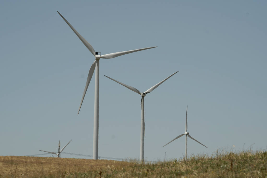 Wind turbines sit on a hill side near Rio Vista, Calif., on Monday, July 25, 2022. California Gov. Gavin Newsom wants to accelerate the state's transition to using clean sources like wind supple electricity in the state. It's part of his proposal to spend $19.3 billion of testate budget on climate policies. (AP Photo/Rich Pedroncelli)