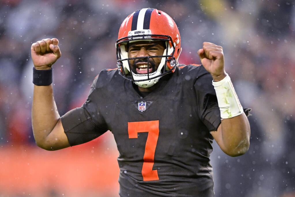 Cleveland Browns quarterback Jacoby Brissett (7) celebrates after handing the ball off to running back Nick Chubb, who scored in overtime of the team's NFL football game against the Tampa Bay Buccaneers in Cleveland, Sunday, Nov. 27, 2022. The Browns won 23-17. (AP Photo/David Richard)