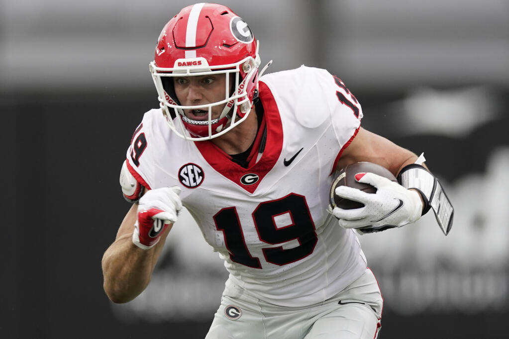 Georgia tight end Brock Bowers (19) runs the ball after a catch against Vanderbilt in the first half of an NCAA college football game Saturday, Oct. 14, 2023, in Nashville, Tenn. Bowers has been selected to The Associated Press midseason All-America team, Wednesday, Oct. 18, 2023. (AP Photo/George Walker IV, File)