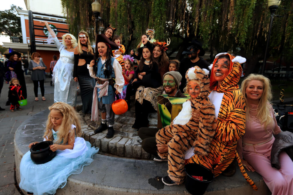 Several people gather for photos dressed in their costumes including Elizabeth Theriault, with daughter, Simone, 3, both of Petaluma, dressed as tigers in front on Halloween, Monday, October 31, 2022, in Petaluma.  (Darryl Bush / For The Press Democrat)