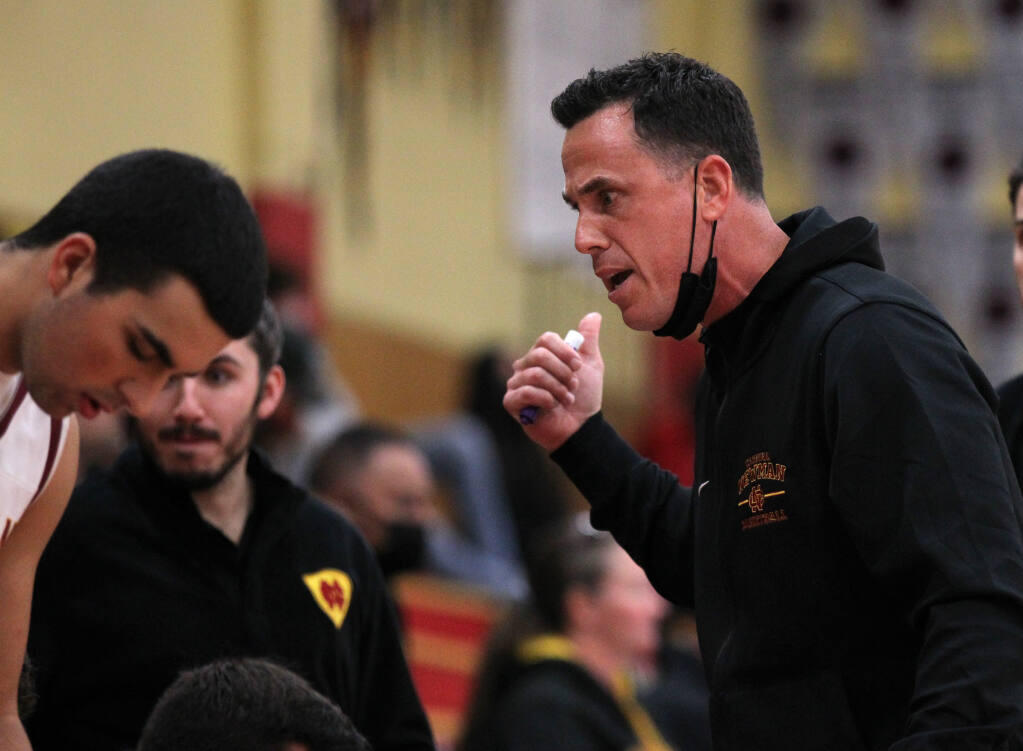 Cardinal Newman's head coach, Travis Taylor, talks to his players on the sideline against Petaluma in the first half of a Rose City Tournament basketball final, played at Cardinal Newman High School in Santa Rosa, Calif., on Saturday, December 11, 2021. (Photo by Darryl Bush / For The Press Democrat)