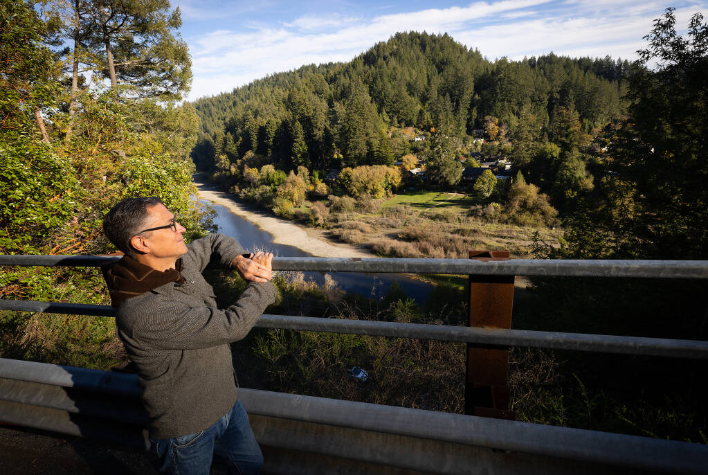 John Dunlap, leader of the Guerneville Forest Coalition, is opposed to a planned 224-acre logging plan above Neeley Road between Guerneville and Monte Rio, shown here at the top of the hill and to the right as he looks across the Russian River near his Guernewood Park home Friday, Nov. 11, 2022. (John Burgess/Press Democrat)